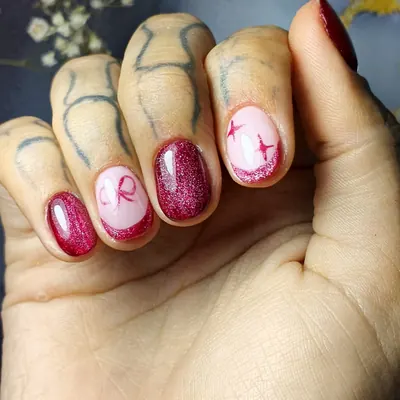 Nivelación burdeos con brillo y uñas decoradas con lazo y estrellas
